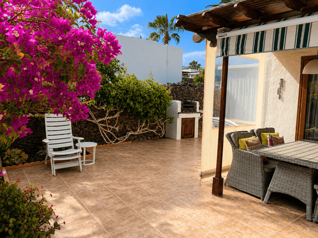 Casa del Sol's outdoor terrace with furniture, tropical flowers and a relaxation area.