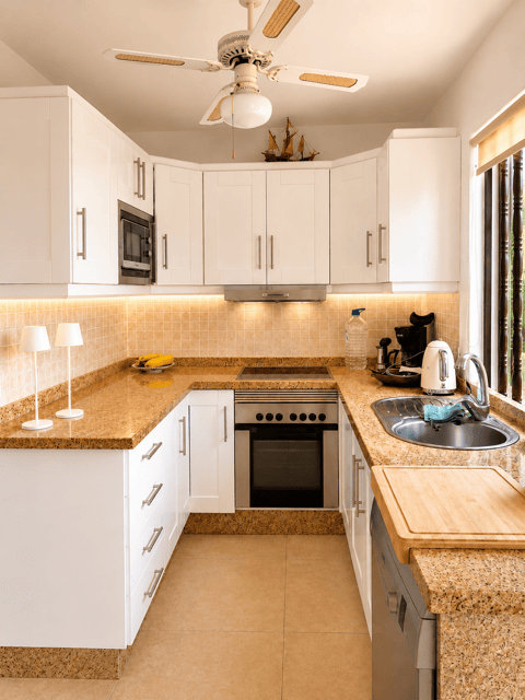 Modern kitchen in Casas del Sol with appliances and cozy space.