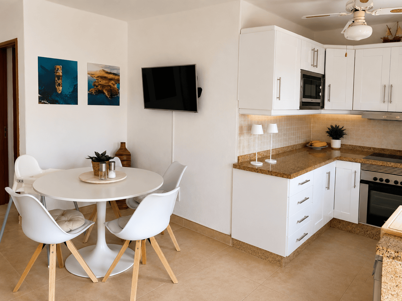 Kitchen and dining room in a Casas del Sol apartment, modern and bright decor.